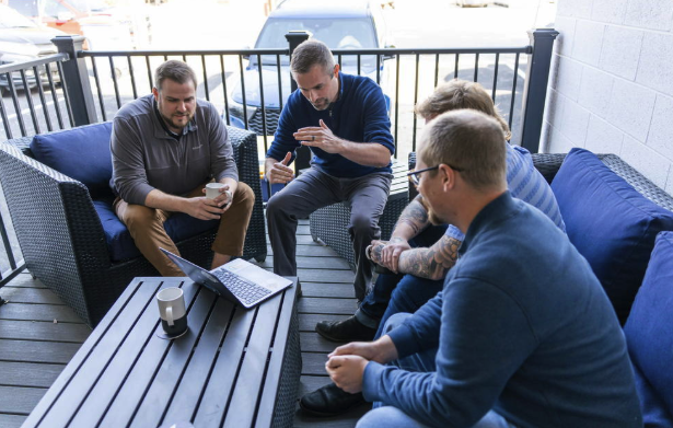 1BoldStep group meeting on a patio with laptop